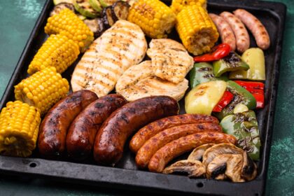 Grilled sausages, meat, and vegetables.