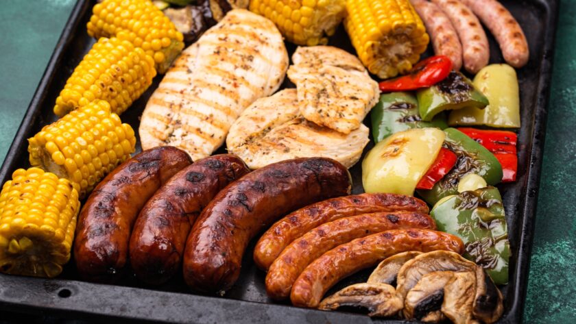 Grilled sausages, meat, and vegetables.
