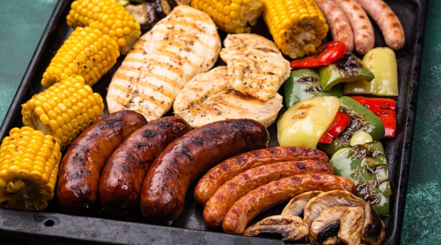 Grilled sausages, meat, and vegetables.