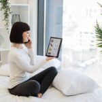 Woman with tablet and mobile ordering food with discount