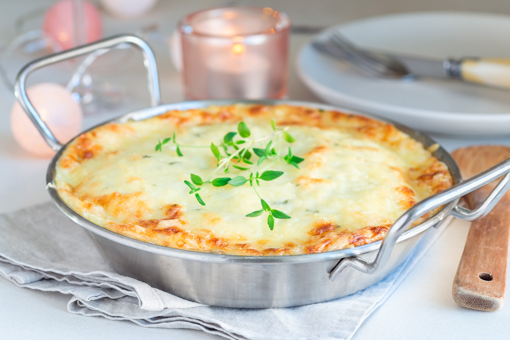 Cheesy scalloped potatoes or potato gratin in baking dish, holid