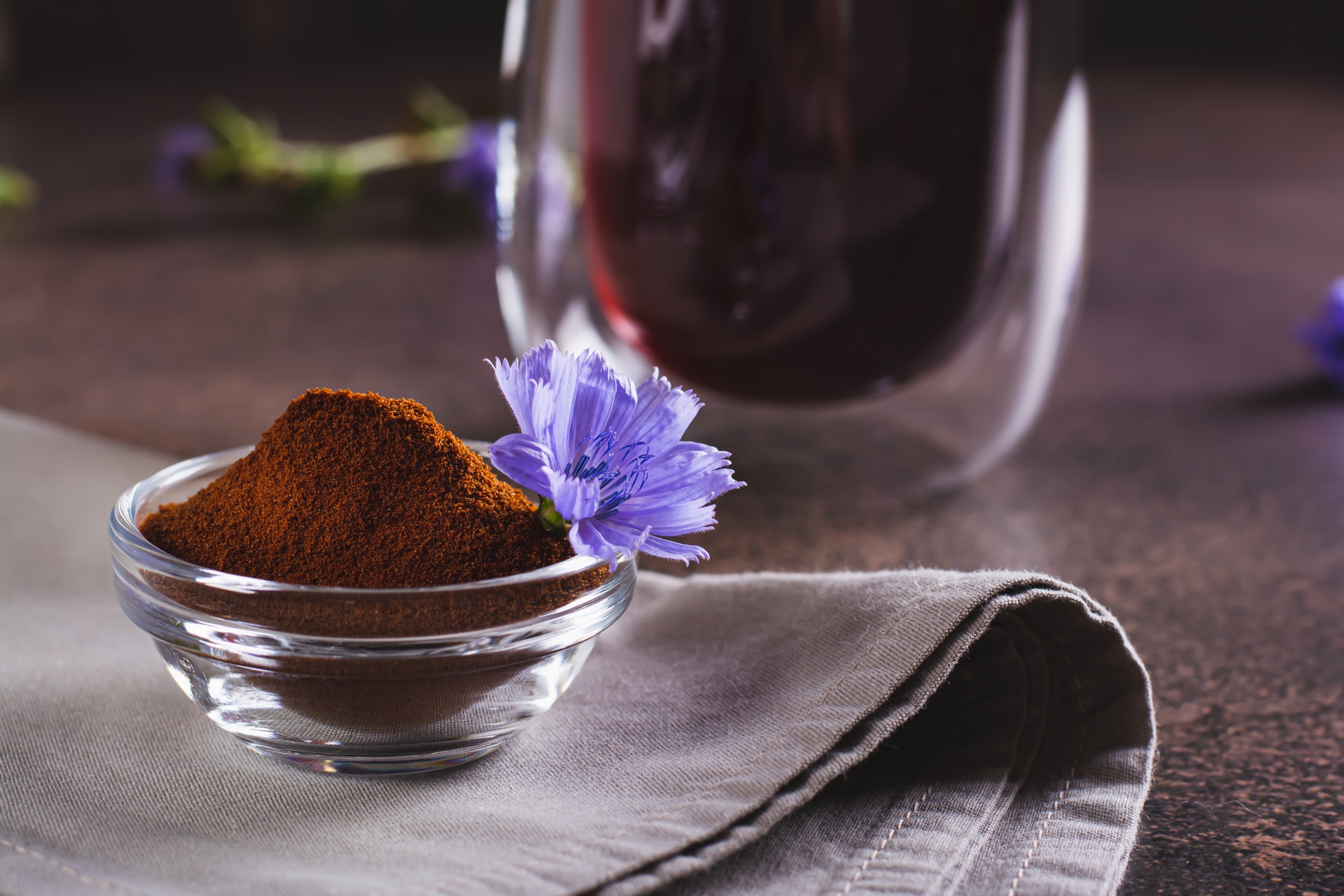 Chicory powder and flower in a bowl for preparing a vitamin drink