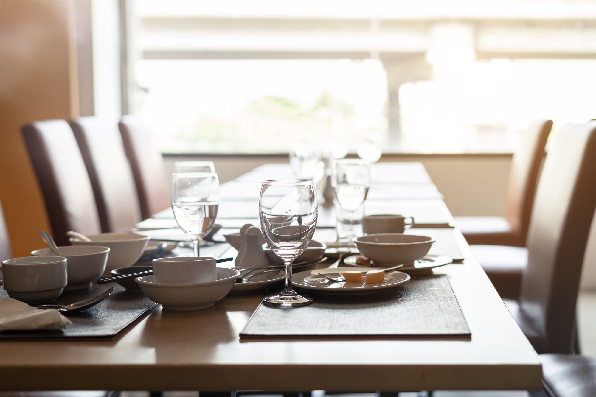 Empty dirty glasses and plates on dinning table in restaurant