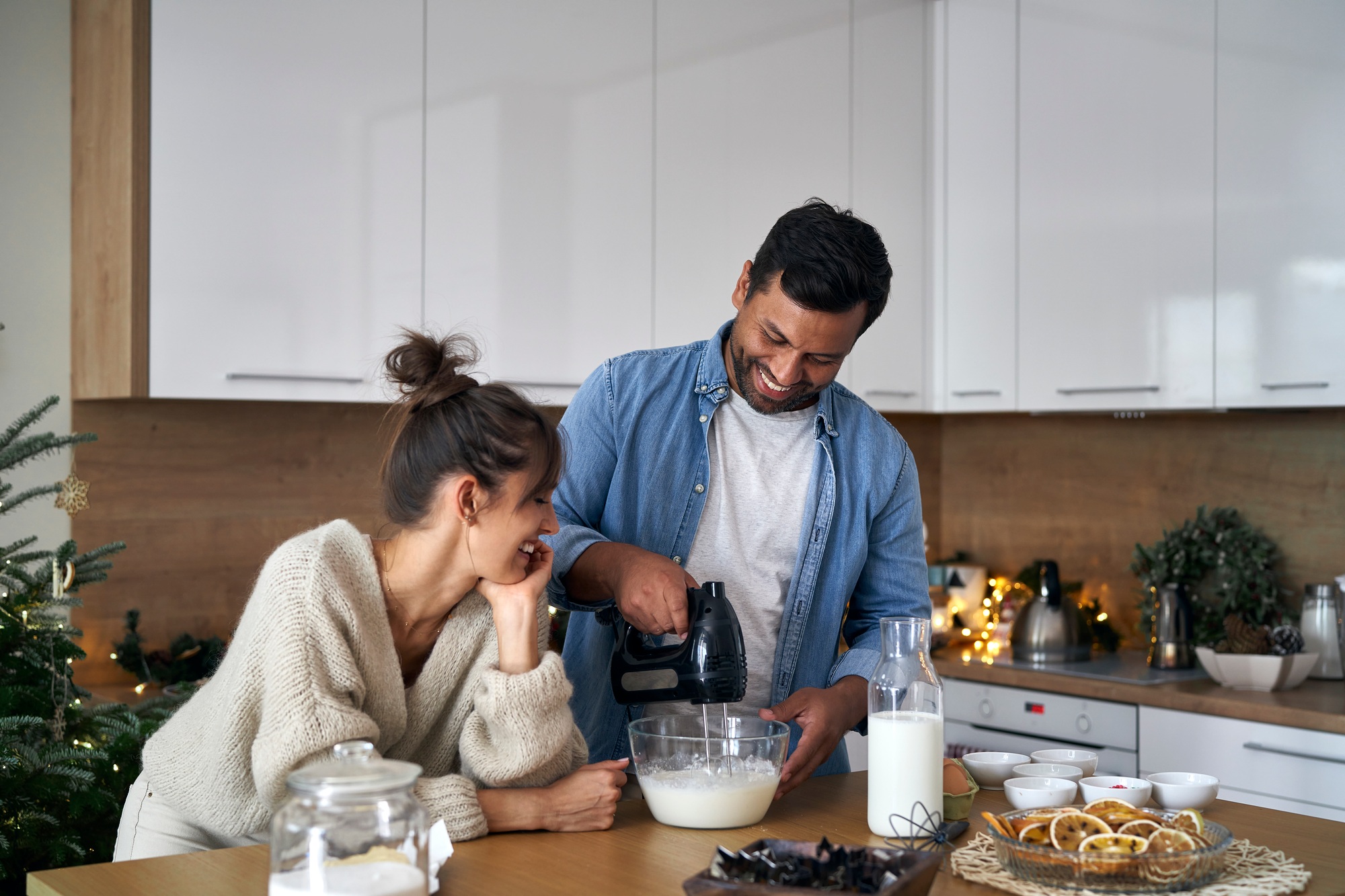 Multi ethnicity couple making a cake in Christmas time