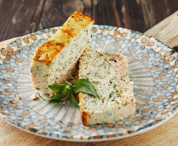 Salmon and dennis pate, sliced slices on plate of basil. French gourmet cuisine