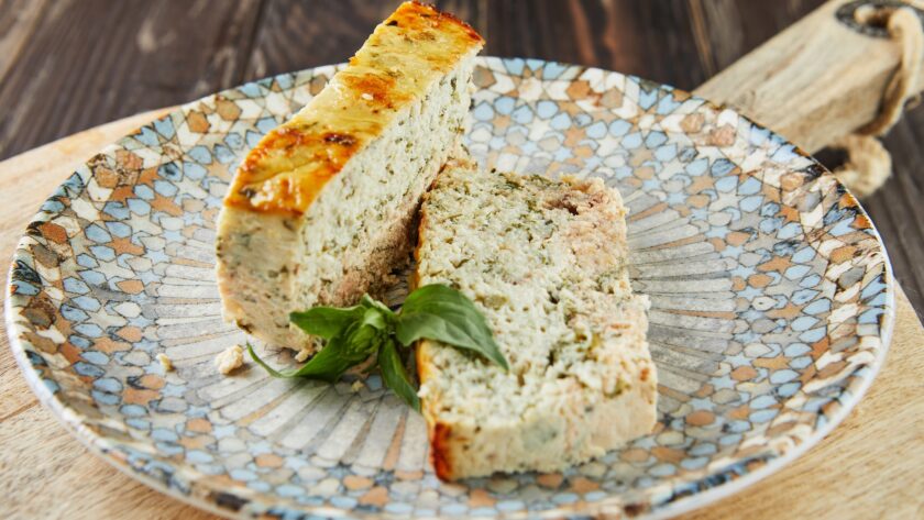 Salmon and dennis pate, sliced slices on plate of basil. French gourmet cuisine