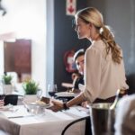 Waitress serving customers in restaurant